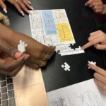 An image of students working on a puzzle